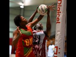 Grenada’s Renisha Stafford tussles with Trinidad and Tobago’s (T&T) Afeisha Noel during their Americas Netball World Cup Qualifiers yesterday at the National Indoor Sports Centre. T&T won 66-42.