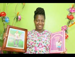 Rasheda Thomas-Bailey with a photograph of her daughter Jerodene Bailey, who was diagnosed with cancer at age four, and died at age seven. She penned her book to share her journey so as to inspire others.