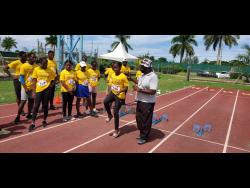 Paul Francis instructs athletes in the sprints technical area at the MVP Grassroots Athletics Programme camp at the Montego Bay Sports Complex, Catherine Hall, on Saturday. 