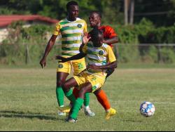 Tivoli Gardens’ Shaquille Jones is sandwiched by Vere United’s Shamar O’Connor (right) and Kayon Henry during their Jamaica Premier League opening match at the Wembly Centre of Excellence yesterday. The match ended in a 1-1 draw.