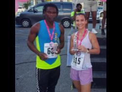 Garth Abbott (left) and Danielle Terrier, the men’s and women’s winners respectively of the Kiwanis Club of Providence, Montego Bay Breast Cancer Awareness 5K Walk/Run and Wheelchair Signature Project held at Fairview in Montego Bay, yesterday.