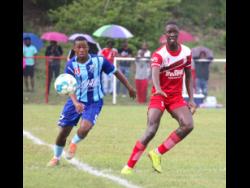 Jhamaleek Porter of Manning’s (left) tussles with Glenmuir’s Ja-son Whyte in their ISSA/Digicel daCosta Cup round-of-16 tie at Glenmuir High yesterday. The match ended in a 0-0 draw.