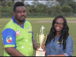 Bridgeport Super Sixers’ captain Jermaine Gordon collects the Jamaica Energy Partners (JEP) trophy from Public Relations Officer of JEP, Moya Hinds.