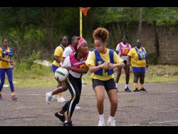 Members of Jackson Town (yellow) engage opponents of Warsop during the netball section of the Social Development (SDC) Trelawny leg of the Four-In-One competition at the Duanvale Community Centre on the weekend.