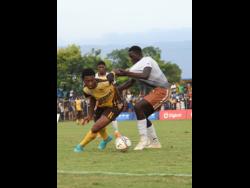 Manchester High’s Yarek Carnegie turns on Central High’s Anrick Gordon during the ISSA/Digicel daCosta Cup semifinal match at St Elizabeth Technical High School (STETHS) yesterday. Central won 5-4 on penalties after both teams had battled to a 1-1 scoreline at the end of regulation time.