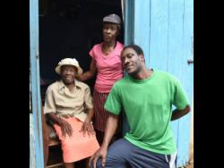 Centenarian Esmine Harrison (left), is surrounded by her daughter Icylin Henry (centre) and grandson, Renford McDonald, at her home in  Bonnett, Guys Hill, St Catherine on Saturday.