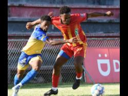 Ronaldo Robinson (left) of Harbour View and Faulkland’s Hasana Johnson battle for the ball during their Jamaica Premier League football match at the Anthony Spaulding Sports Complex yesterday. Harbour View drubbed Faulkland 6-1.
