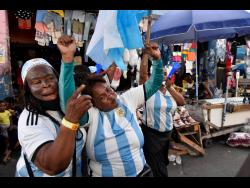 Supporters clad in Argentina jerseys celebrate on Princess Street in downtown Kingston, as their team progressed to the World Cup final yesterday.