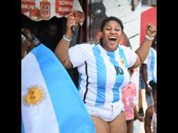 Argentina supporter Tashine Wright was seen at Sharon and Chenab endz on Molynes Road, Kingston, celebrating her team’s World Cup win yesterday.