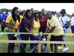 Member of Parliament for western Hanover Tameka Davis (left), Principal Donna Anderson (second left), Vilma Miller, wife of the late Collin Miller (centre),  and former teacher and president of Rusea’s BrotherSister Foundation Inc (BroSis), Troy ‘Bulla’ Malcolm (second right) cut the ribbon to signal the official state-of-the-art changing room to be built at the Collin Miller Sports Complex in Lucea, Hanover, on Saturday.