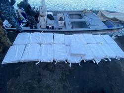 Members of the Jamaica Defence Force unload cocaine from this vessel, which was intercepted close to St Thomas on Monday.
