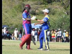 Christopher Gayle (left) is greeted by Brian Lara following his dismissal for 52 during the Legends T20 match at the Treasure Beach Sports Complex in St Elizabeth.