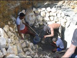 These men were among scores of persons who spent days digging for a mineral in Yanique Cole’s absorption pit that was under construction. Residents thought they had found gold.
