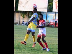 Keithy Simpson (left) of Waterhouse FC heads the ball ahead of Tevin Scott of Portmore United in their Jamaica Premier League (JPL) match at the Waterhouse Mini Stadium yesterday. The matched ended in a 1-1 draw.