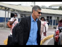 Chapelton Maroons’ new coach Clovis De Oliveira exits the Norman Manley International Airport yesterday, after arriving on the island.