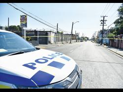 Police and crime scene detectives process a murder scene on Orange Street in Kingston last month.