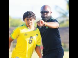 Coach Merron Gordon instructs midfield substitute Jordan Mangatal before he enters the field in a practice match against Jamaica Premier League outfit Vere United at the Wembley Centre of Excellence recently.