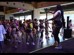 Kimiko Versatile takes participants through the dancehall moves, step by step, during a master class. 