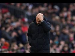 Manchester City’s head coach Pep Guardiola reacts during the English Premier League match between Manchester United and Manchester City at Old Trafford in Manchester, England, on  Saturday, January 14, 2023. 