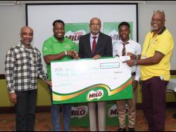 
Chevanne Lawrence (second left), regional consumer marketing manager, Milo, hands over a cheque for  $4 million to Ray Harvey (centre), chairman of the Western Relays,  at the launch of this year’s meet at the Deja Resort in Montego Bay yesterday.  Also in photograph (from left) are  Christopher Samuda, president of the Jamaica Olympic Association,  Rlandi Wright, student of Green Island High School and Tony Myers, meet manager, Western Relays.