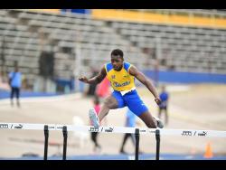 Shamer Blake wins his Class I boys 400 metres heat at Champs last year.