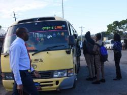 Loitering students being ushered to a bus by their principals and other school administrators on Thursday in the Montego Bay Transportation Centre.