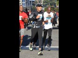Prime Minister Andrew Holness (centre) participating in the Sagicor Sigma Corporate Run held in New Kingston yesterday. Dubbed the ‘Legacy Run’, this year’s race  aimed to raise upwards of $75 million in aid of the University Hospital of the West Indies’ Paediatric Unit, as well as the Edna Manley College for the Visual and Performing Arts.  A record-breaking $91.8 million was raised.