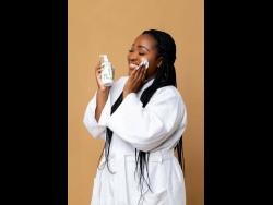 Believing in one of her own products, Krishendaye Ivey applies some NiKS Skincare cream to her face.