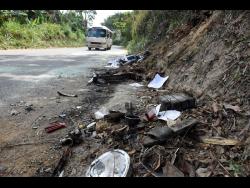 Parts of motorcycles lay on the side of the Temple Hall main road where the five relatives crashed and died on Sunday night.