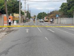 Police cordon the crime scene at the intersection of Whitfield Avenue and Rose Town where a man was shot and injured by gunmen.