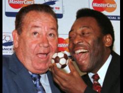 Football legend Pele (right) of Brazil feeds French football legend Just Fontaine with a football-fashioned cake on Sunday, July 5, 1998, in Paris. Fontaine, whose 1958 record of 13 goals scored during a World Cup still stands, has died. He was 89. His former club, Reims, announced Fontaine’s death yesterday. Pelé died last year.