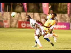 Nicholas Nelson (right) of Molynes United tackles Ronaldo Christian of Chapelton Maroons during their Jamaica Premier League (JPL) game at the Anthony Spaulding Sports Complex yesterday. Molynes won 3-1.