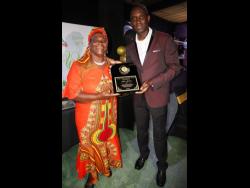 Angella Jackson was one of the 46 recipients of the Community Hero Award. Here she collects a plaque on behalf of her husband, Aden Jackson, a retired school principal.