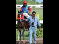 BOOTYLICIOUS’ trainer Ian Parsard (right)