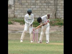 Excelsior High School’s Javier Williams (right) is bowled for nought by Matthew Aljoe (out of picture) of Wolmer’s Boys’ School while wicketkeeper Jose Northover watches during their Grace Shield semifinal at Kensington Cricket Club on Tuesday. Aljoe claimed eight wickets in the match to help Wolmer’s reach the final against St Jago.