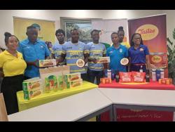 From left: Crystal Blackwood, brand manager National Bakery; Keith Salesman, Waterhouse manager;  Devonte Walker, player; Elvis Wilson, player; Javain Linton,  player; Marcel Gayle, coach; Jermaine Morgan, player; and Antoneil Dinnall, customer service specialist at Dairy Industries/Tastes Cheese share lens at Dairy Industries Eastern handover to Waterhouse.