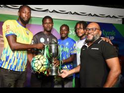 Vernon James (right) CEO, Lynk, poses with the Lynk Cup  and players from various teams in the Jamaica Premier League (JPL) during the media launch of the Lynk Cup last Wednesday at Devon House.  The players are (from left) Jermy Nelson - Molynes FC, Kyle Ming – Cavalier, Oshane Staple - Harbour View and Alex Marshall, Portmore United.  