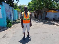 Unofficial traffic warden Telbert Morrison said he volunteers 12 hours daily, rain or shine, to ensure that traffic runs smoothly.