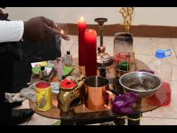 Obeahman Ruben Williams at work in his St Mary office. 