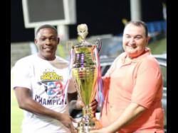 Jamaica’s Sheldon Cottrell (left) posing with the Cool & Smooth T20 trophy, which he won with Bethesda Golden Eagles in 2018. Sharing the occasion is Amer Hourani, director of Cool & Smooth T20.