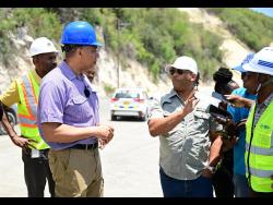 Member of Parliament for St Thomas Western James Robertson (second right) tells Prime Minister Andrew Holness (left) about the inclusive design of the southern highway to enable commuters to access the Grants Pen community.
