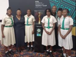 Minister of Culture,Gender, Entertainment and Sport, Olivia Grange (second left), and Reggae Girlz coach Lorne Donaldson (third right) share the occasion with Excelsior High School’s schoolgirl footballers at the launch of the FIFA Women’s World CupTrophy tour yesterday at The Jamaica Pegasus hotel.