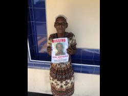 Vivienne Coultman holds a photo of her missing spouse Noel Montaque.