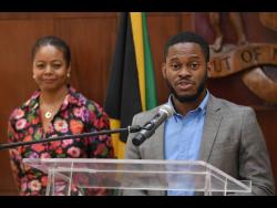 Constitutional Reform Committee Member, Sujae Boswell (right), speaking at a recent press conference at Jamaica House. Listening is Minister of Legal and Constitutional Affairs and Committee Chair, Marlene Malahoo Forte.