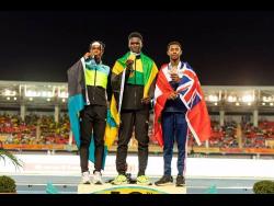 Jamaica’s Courtney Williams (centre) shows off the gold medal he won at the 50th Carifta Games in Nassau, Bahamas, recently, ahead of the Bahamas’ Lavar Deveaux (left) and Bermuda’s Jauza James.  
