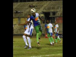 Mount Pleasant FA’s Atapharoy Bygrave (second left) and Montego Bay United Fc’s Nazime Grant duel for the ball during a Jamaica Premier League (JPL) football match at the Montego Bay Sports Complex in Catherine Hall  on April 3. The match drew 2-2.