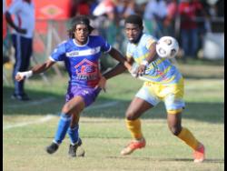 Portmore United’s Alex Marshall (left) battles with Waterhouse’s Keithy Simpson during their Jamaica Premier League (JPL) football match at the Ferdie Neita Park yesterday. The match drew 1-1.