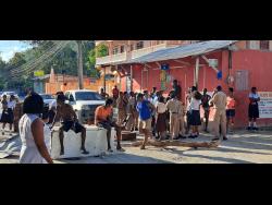 Protesting residents of Fairy Hill, Portland, blocked the roadway yesterday to bring attention to their plight. 
