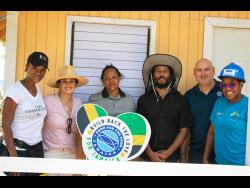 Recipient Kim Plunket (third left) is flanked by (from left) ‘BossMom’ Michelle Gordon, Orly and Ziggy Marley, Craig Moss Solomon, executive director Food For The Poor (FTTP), and Marsha Burrell, marketing manager at FFTP.
