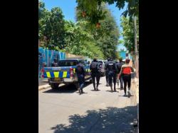 Police scour areas of Ramsey Road and Harris Street in Kingston on Tuesday, following reports of loud explosions.